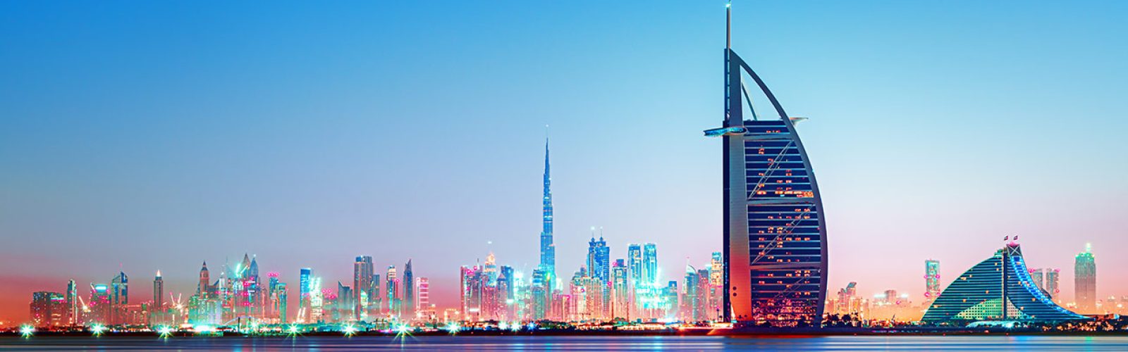 Dubai - amazing city center skyline and famous Jumeirah beach at sunset, United Arab Emirates