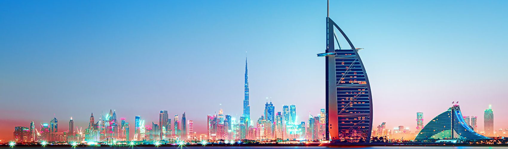 Dubai - amazing city center skyline and famous Jumeirah beach at sunset, United Arab Emirates